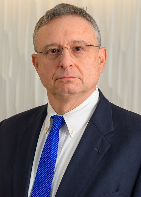 Alan Hartman, MD, wearing a blue tie and blue suit